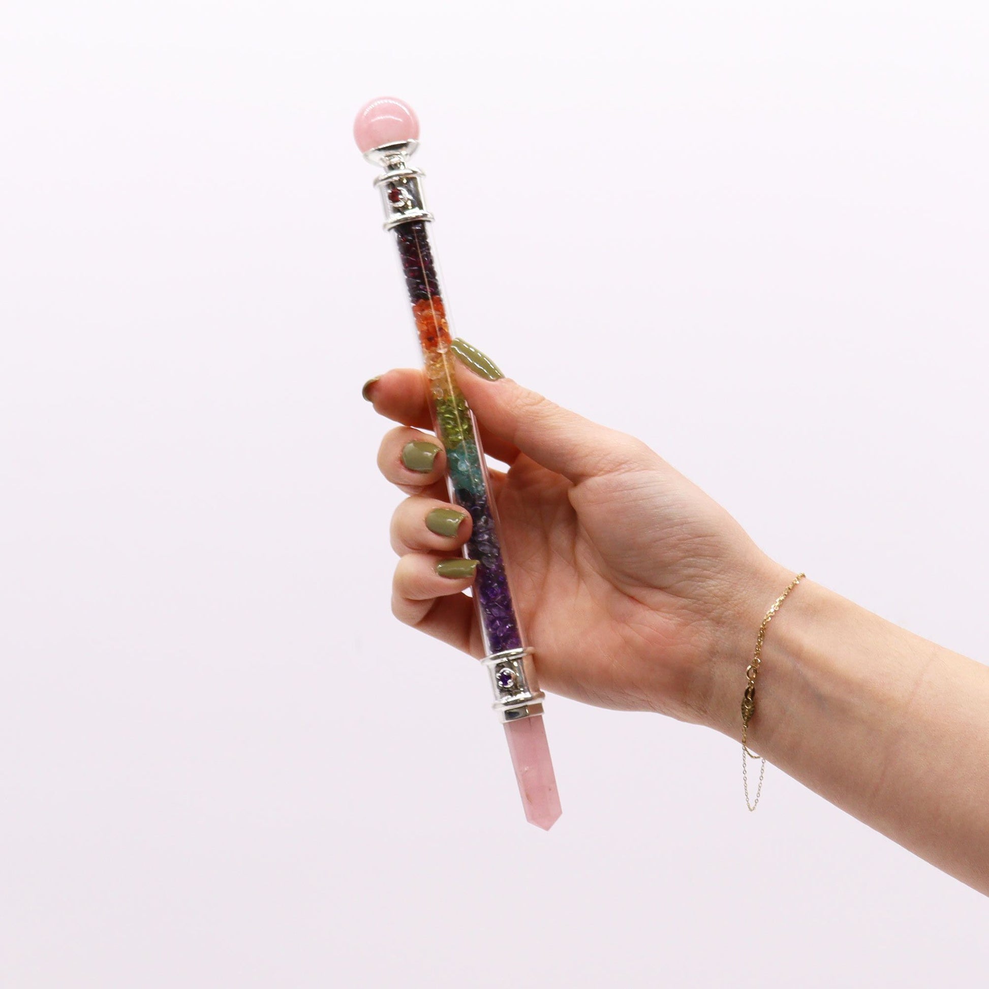 Rose quartz crystal healing wand featuring seven colourful chakra stones set into a polished pink quartz base.