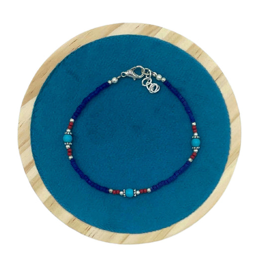 Handcrafted gemstone bracelet featuring smooth, round blue onyx beads with traditional Nepalese artistry.