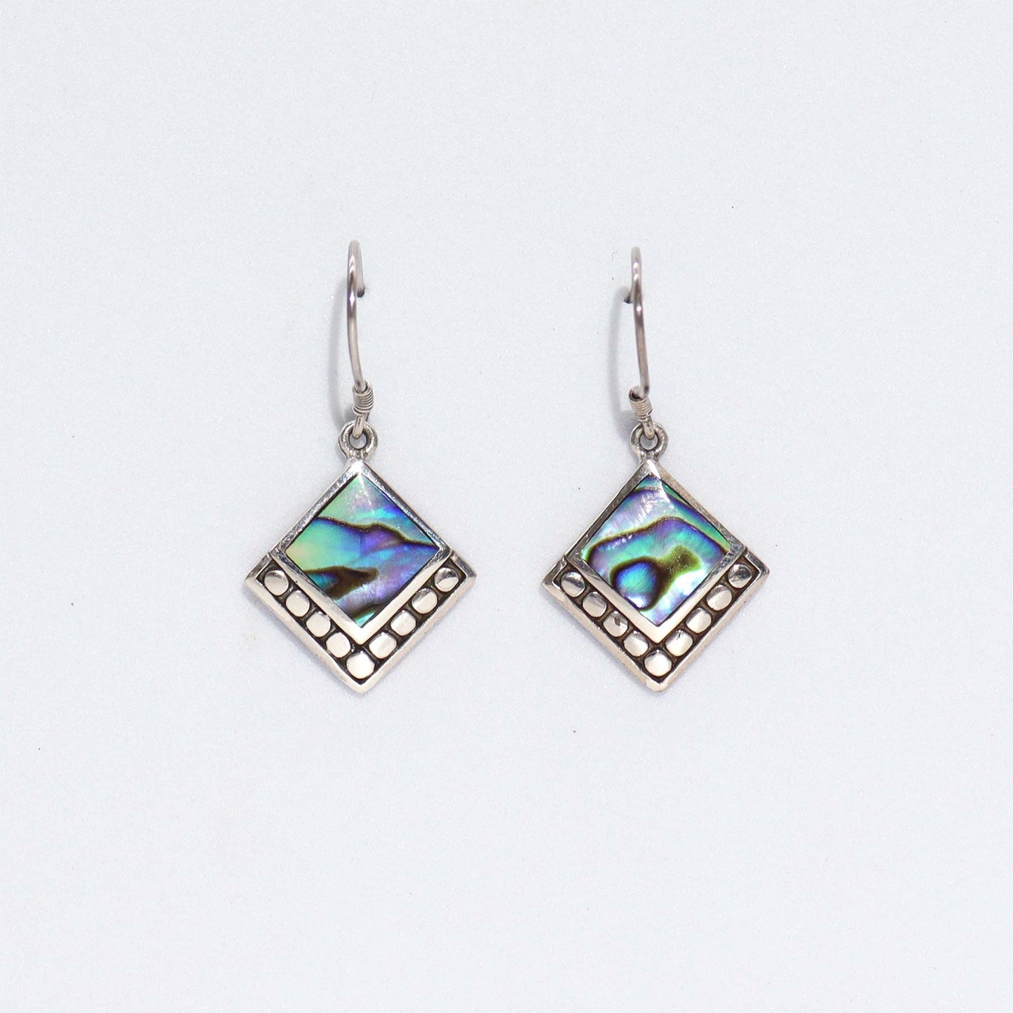 Square abalone shell earrings with shimmering blue and green iridescent tones set in polished sterling silver.