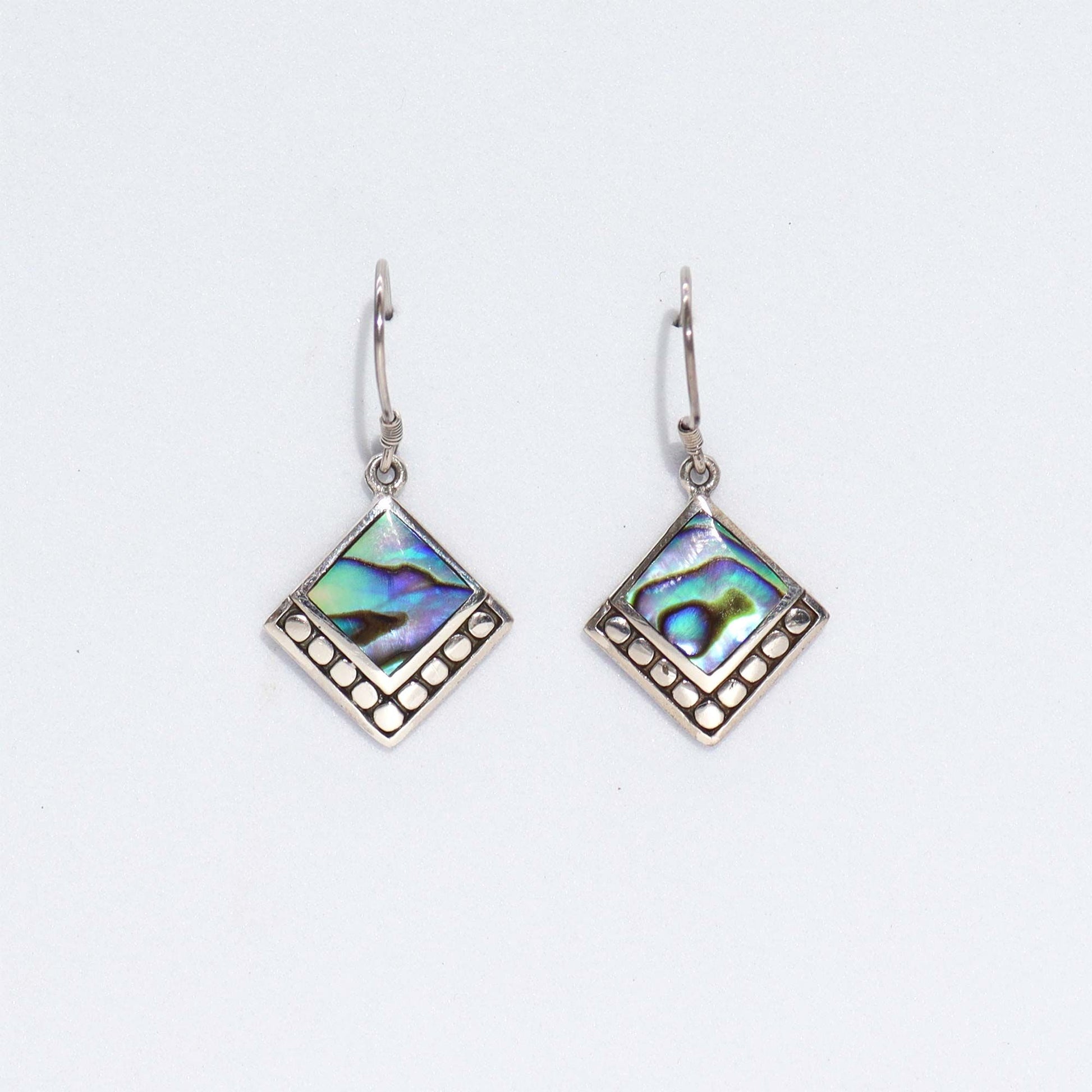 Square abalone shell earrings with shimmering blue and green iridescent tones set in polished sterling silver.