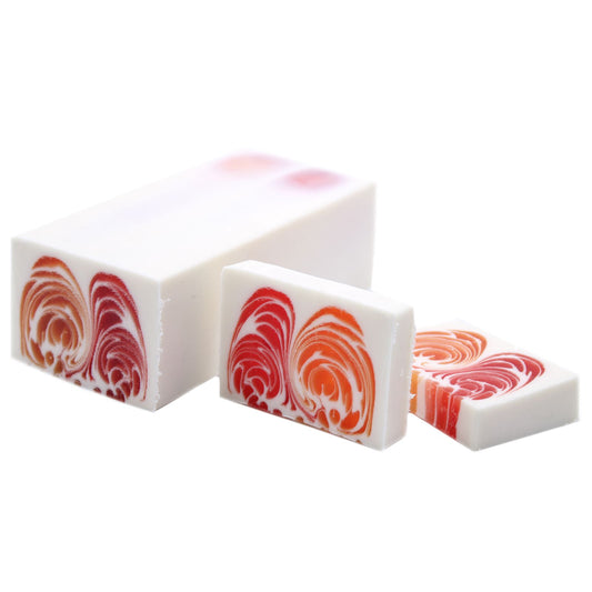 A large, artisanal handcrafted soap loaf with a vibrant grapefruit scent and natural textured finish.
