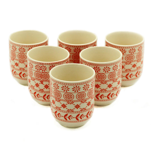 Pair of translucent amber-coloured glass tea cups with a minimalist design for herbal infusions.