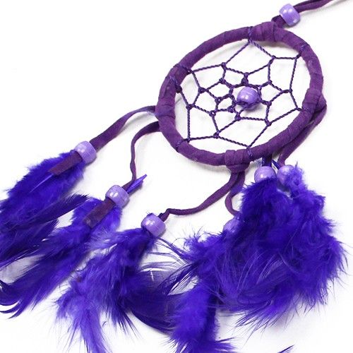 Small round handcrafted dreamcatcher with vibrant turquoise, pink, and purple threads, feathers, and beads.