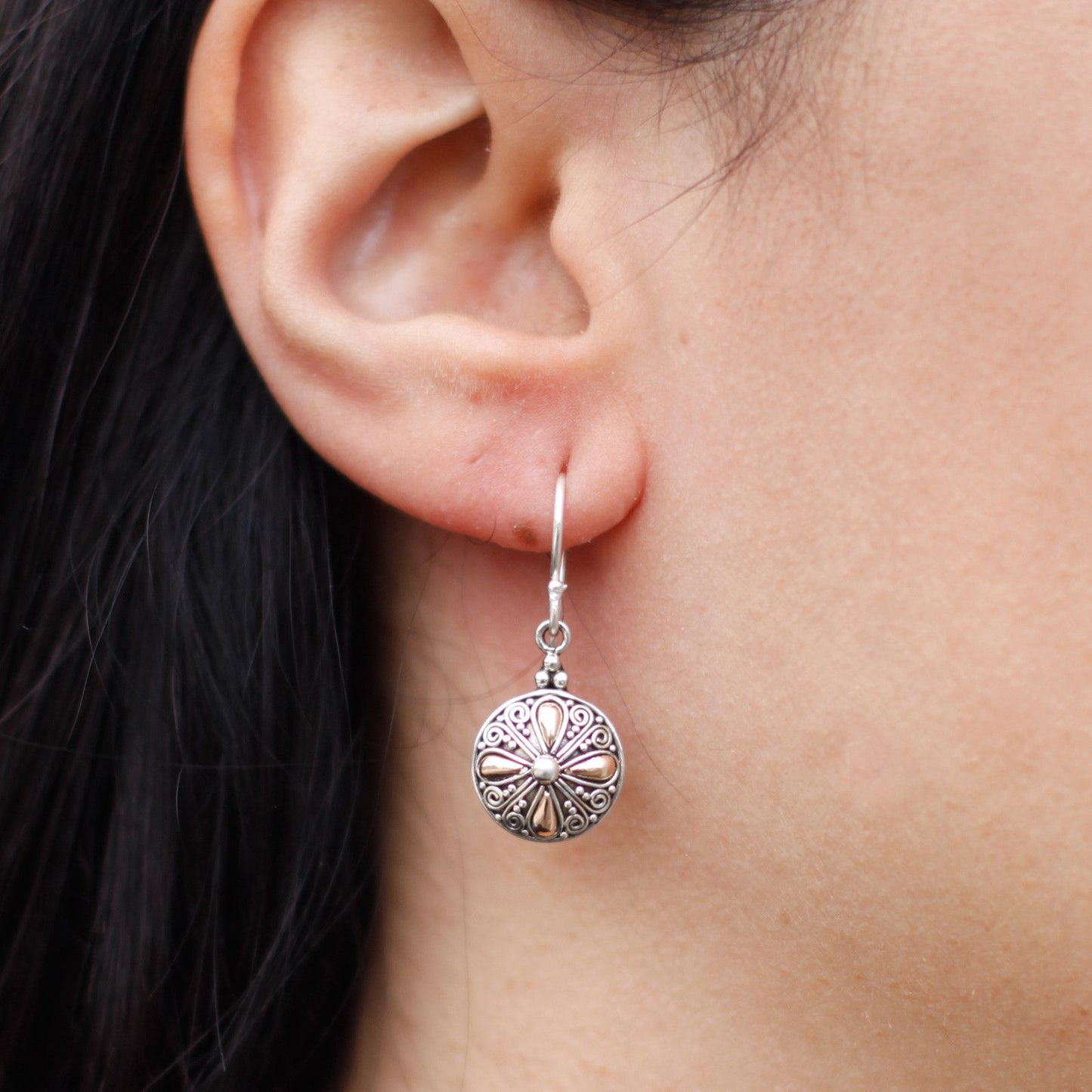 Elegant mixed metal earrings featuring a classic round design in polished silver and gold finishes.