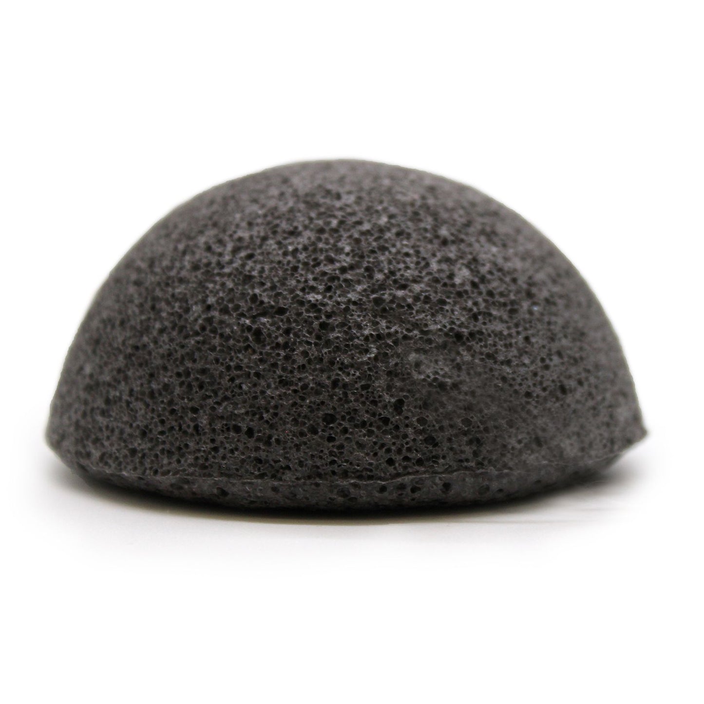 Round black charcoal-infused konjac facial sponge with a soft, porous texture and a small hanging string.