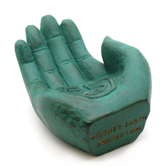 Unique green stone incense burner shaped like a hand, designed to hold fragrant incense cones.