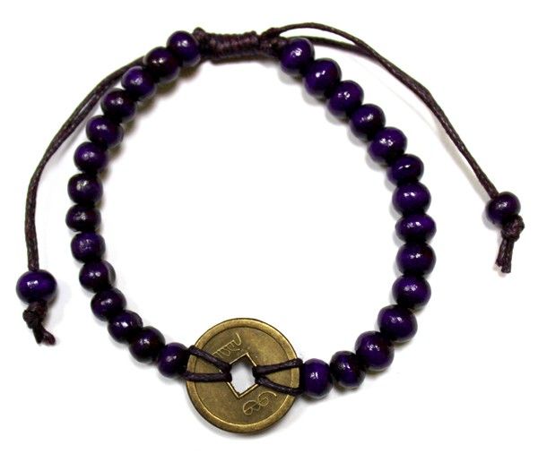 Stretch bracelet featuring purple wood beads and three traditional Chinese fortune coins with a square centre hole.