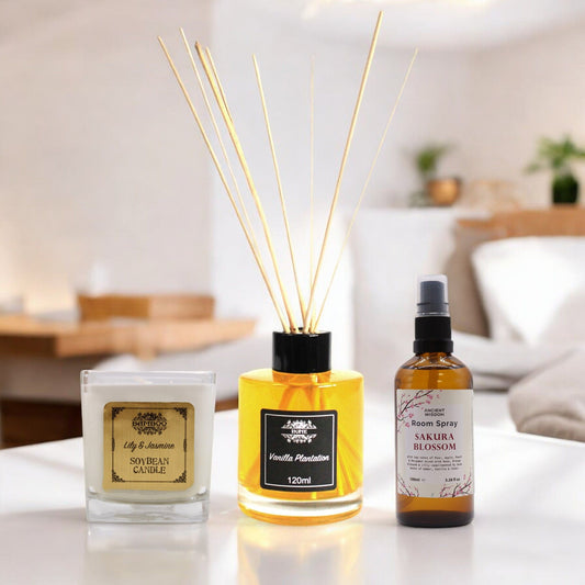 Elegant home fragrance gift set featuring a vanilla reed diffuser with natural wooden sticks on a neutral background.