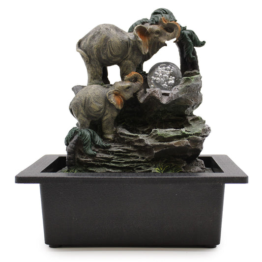 Detailed tabletop water feature depicting a family of elephants surrounding a central water flow in a grey stone effect.