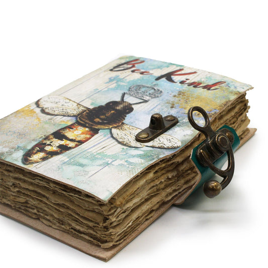 Handcrafted brown leather notebook with an embossed Bee Kind design and rustic deckle-edge vintage paper.