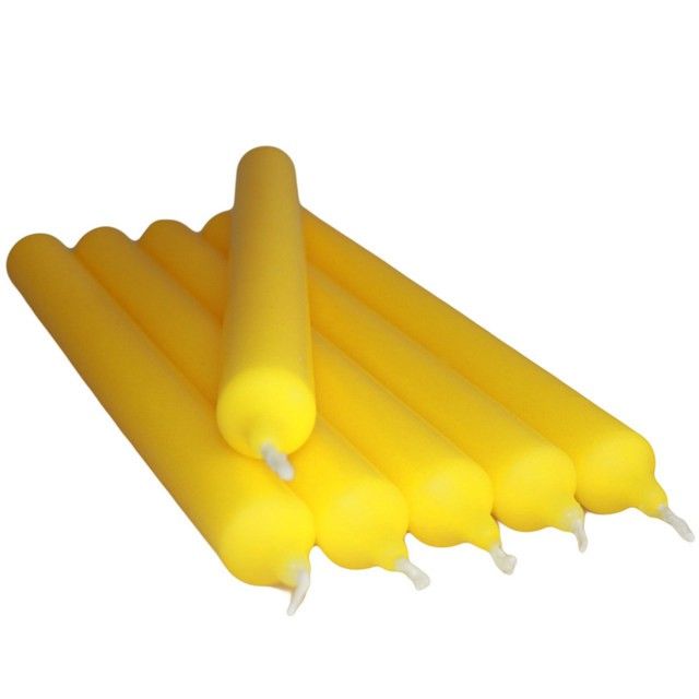 Tall, vibrant citrus yellow dinner candle with a smooth finish, standing in a classic holder.
