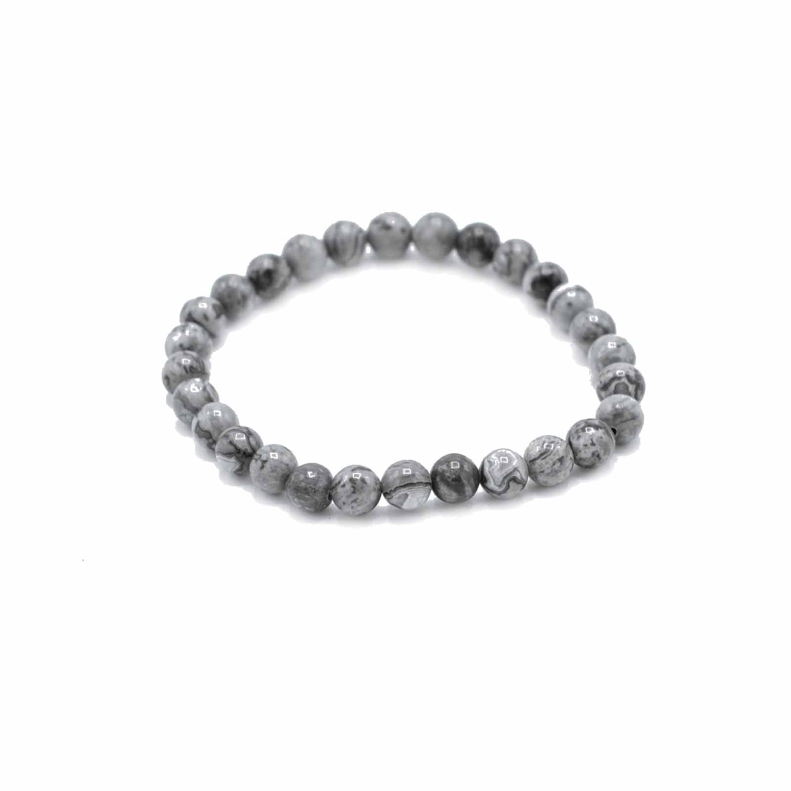 Close-up of a beaded gemstone bracelet featuring grey and black marbled Map Stone beads on an elastic cord.