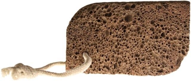 Porous grey volcanic lava foot stone in an ergonomic lemon shape for exfoliating hands and feet.