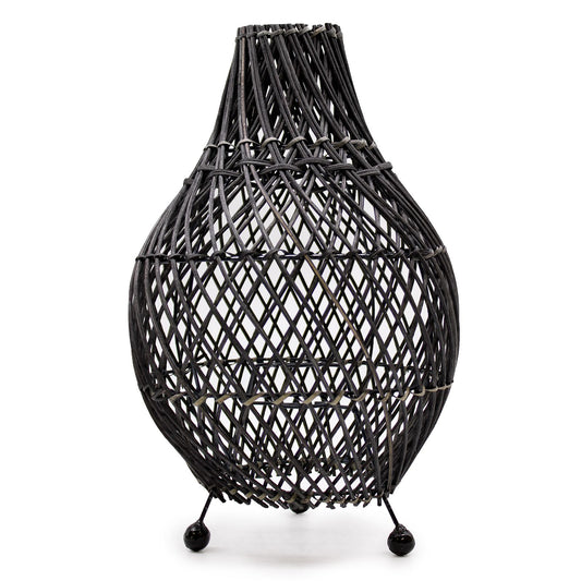 Handcrafted black natural rattan table lamp with intricate woven patterns and a minimalist cylindrical design.