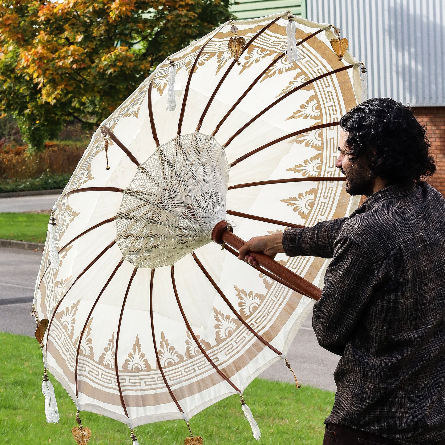 Elegant handcrafted Balinese patio parasol made from natural canvas and durable wood, perfect for garden shade.