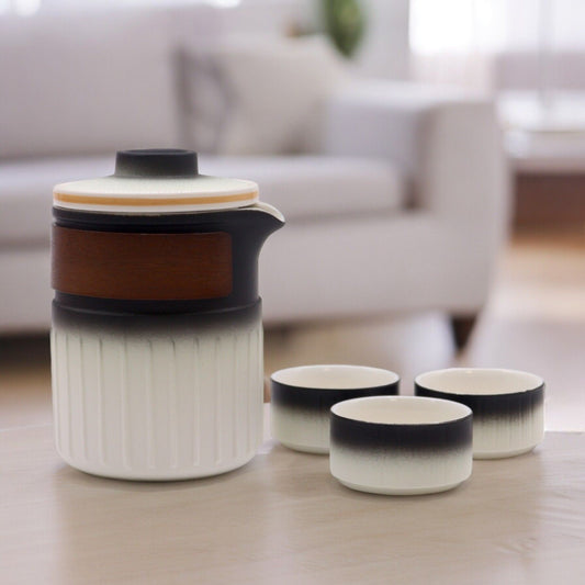 Minimalist travel ceramic teapot and cups featuring a smooth white and black gradient finish in a compact carry case.
