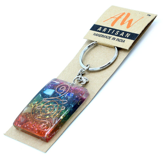 Circular orgonite keyring featuring copper shavings and multi-coloured chakra stones set in clear resin.