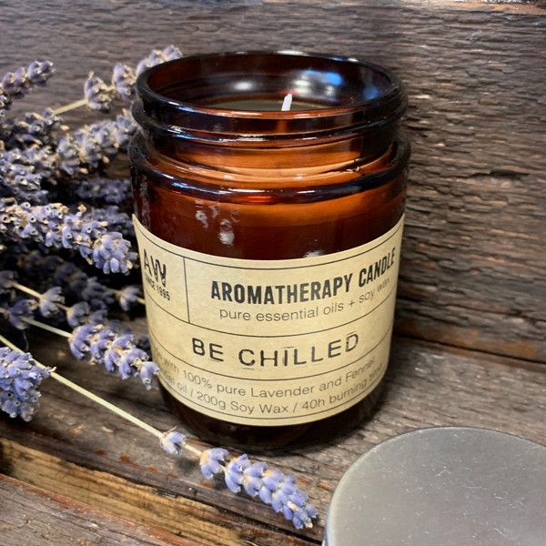Hand-poured aromatherapy soy wax candle in a simple glass jar with a minimalist label on a neutral background.