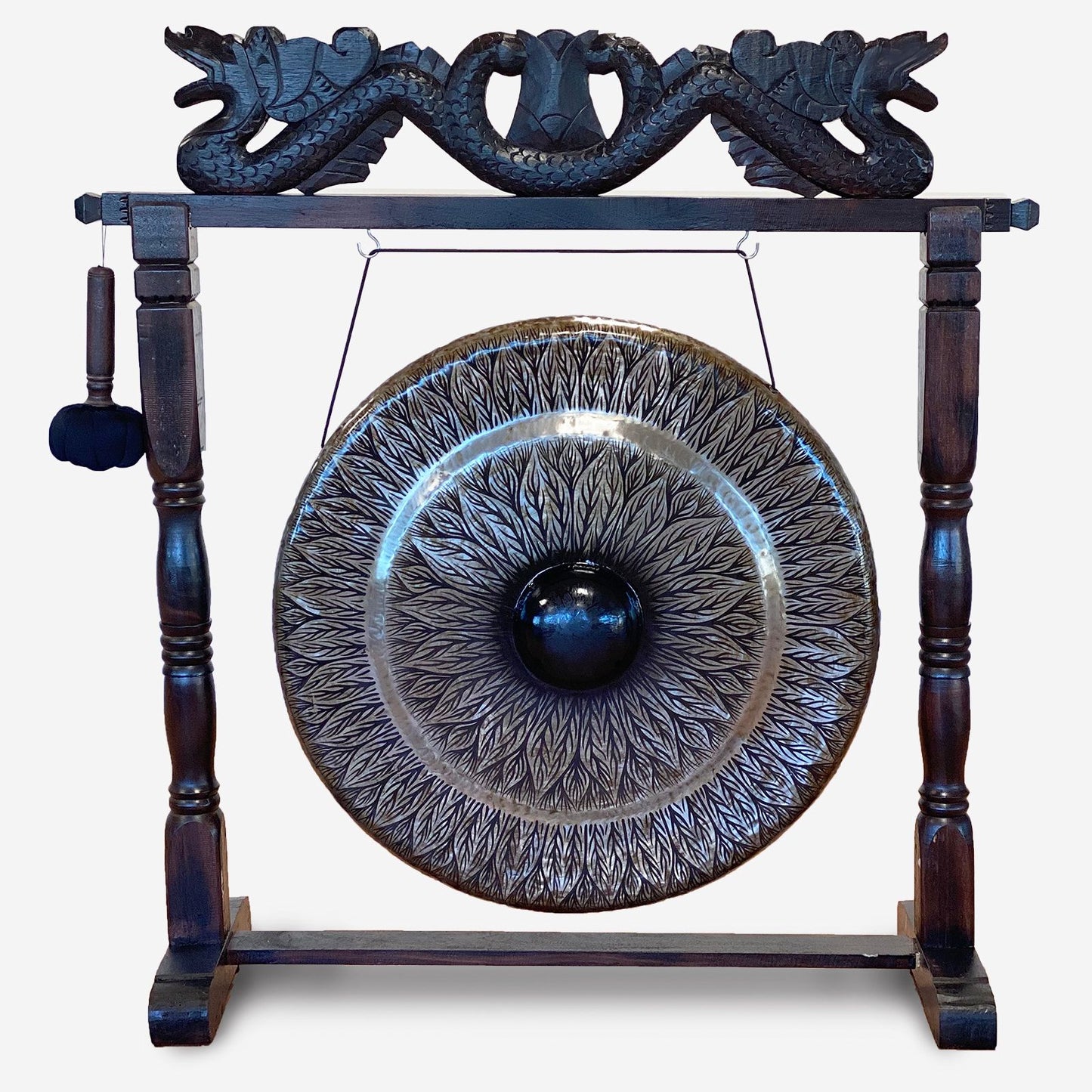 Large black patterned gong suspended in a decorative brown antique-style wooden carved stand.