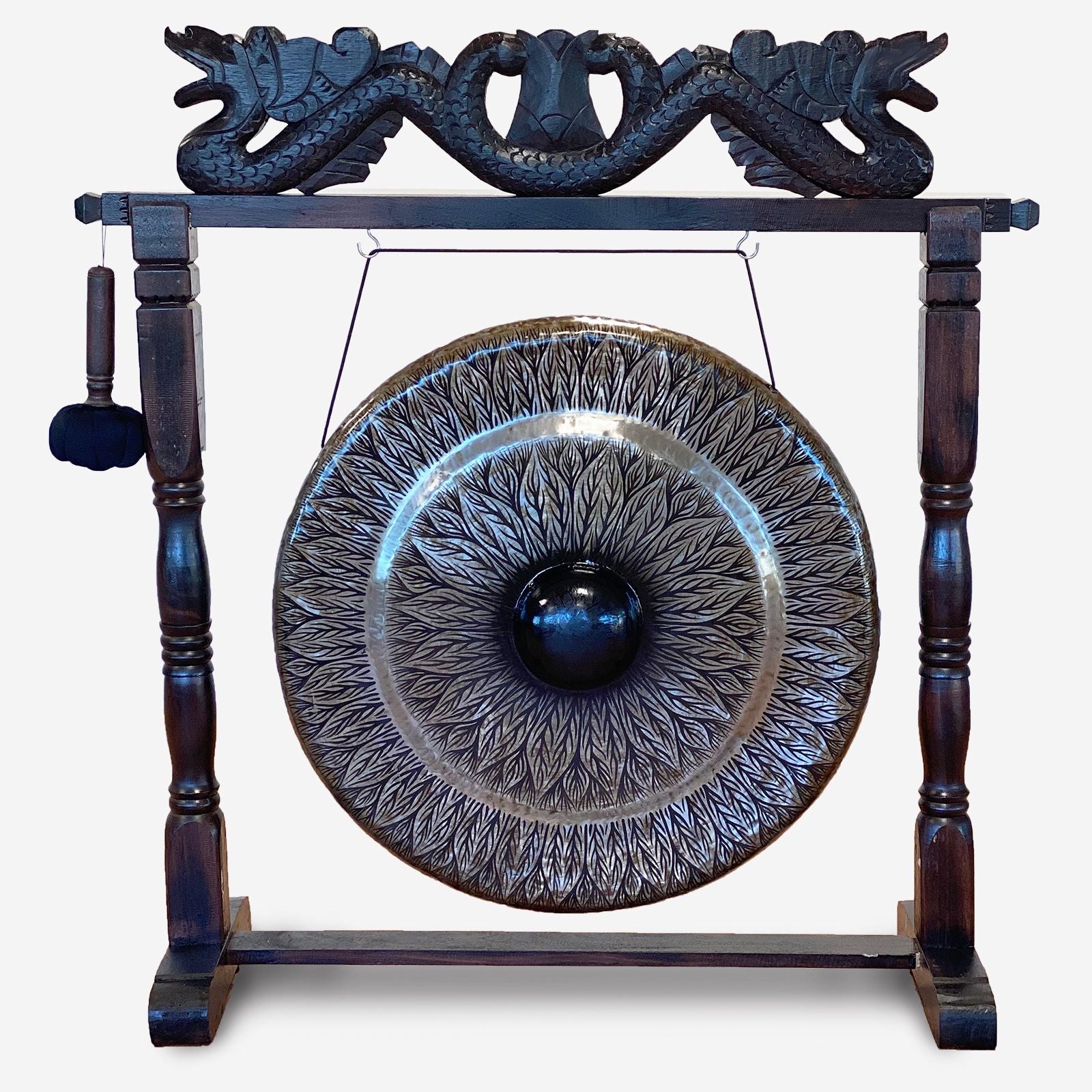 Large black patterned gong suspended in a decorative brown antique-style wooden carved stand.