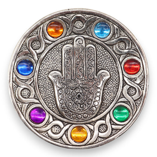 Handcrafted silver-coloured aluminium Hamsa hand incense holder decorated with seven colourful chakra stones.