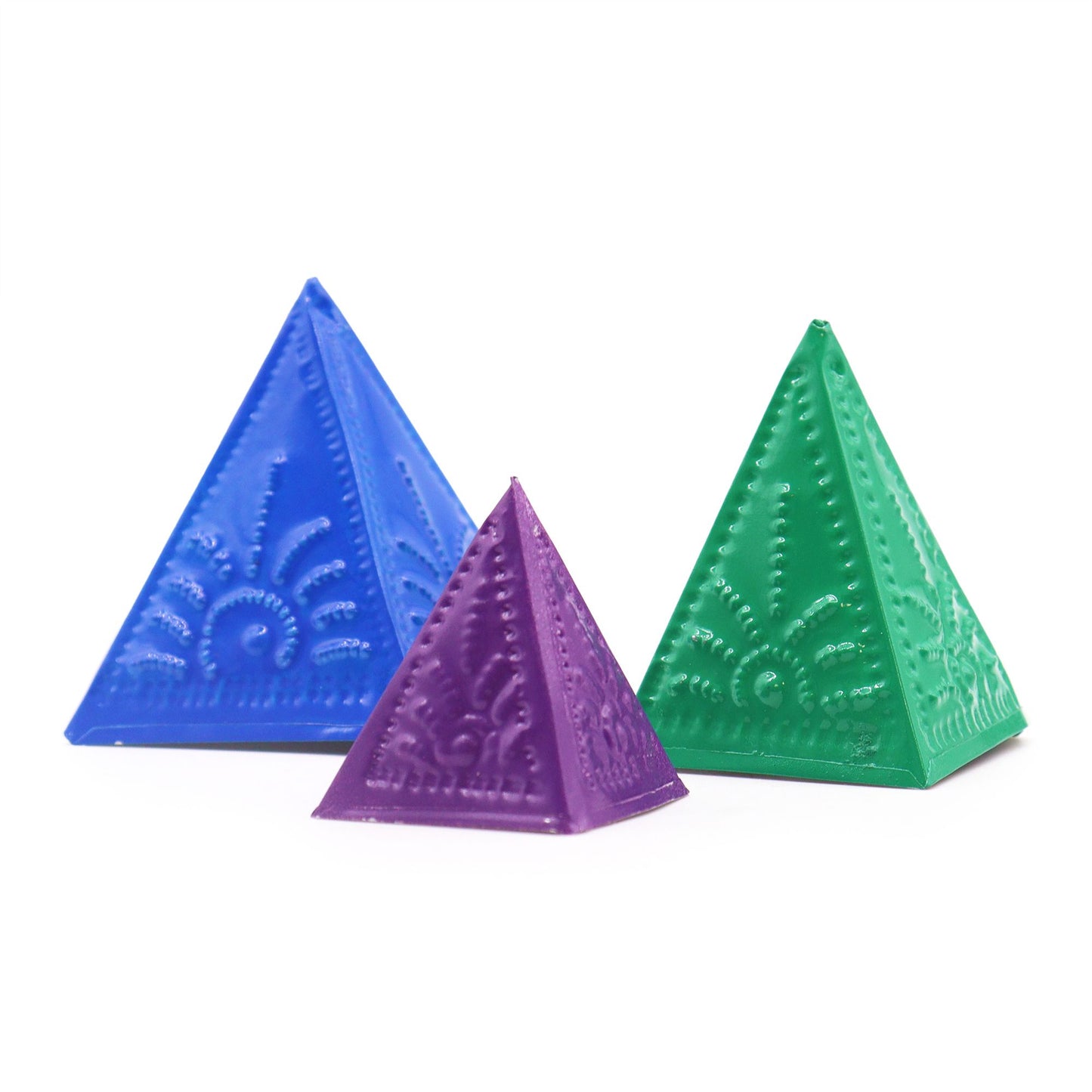 Three pyramid-shaped incense powder moulds in vibrant shades of blue, green, and purple on a neutral background.