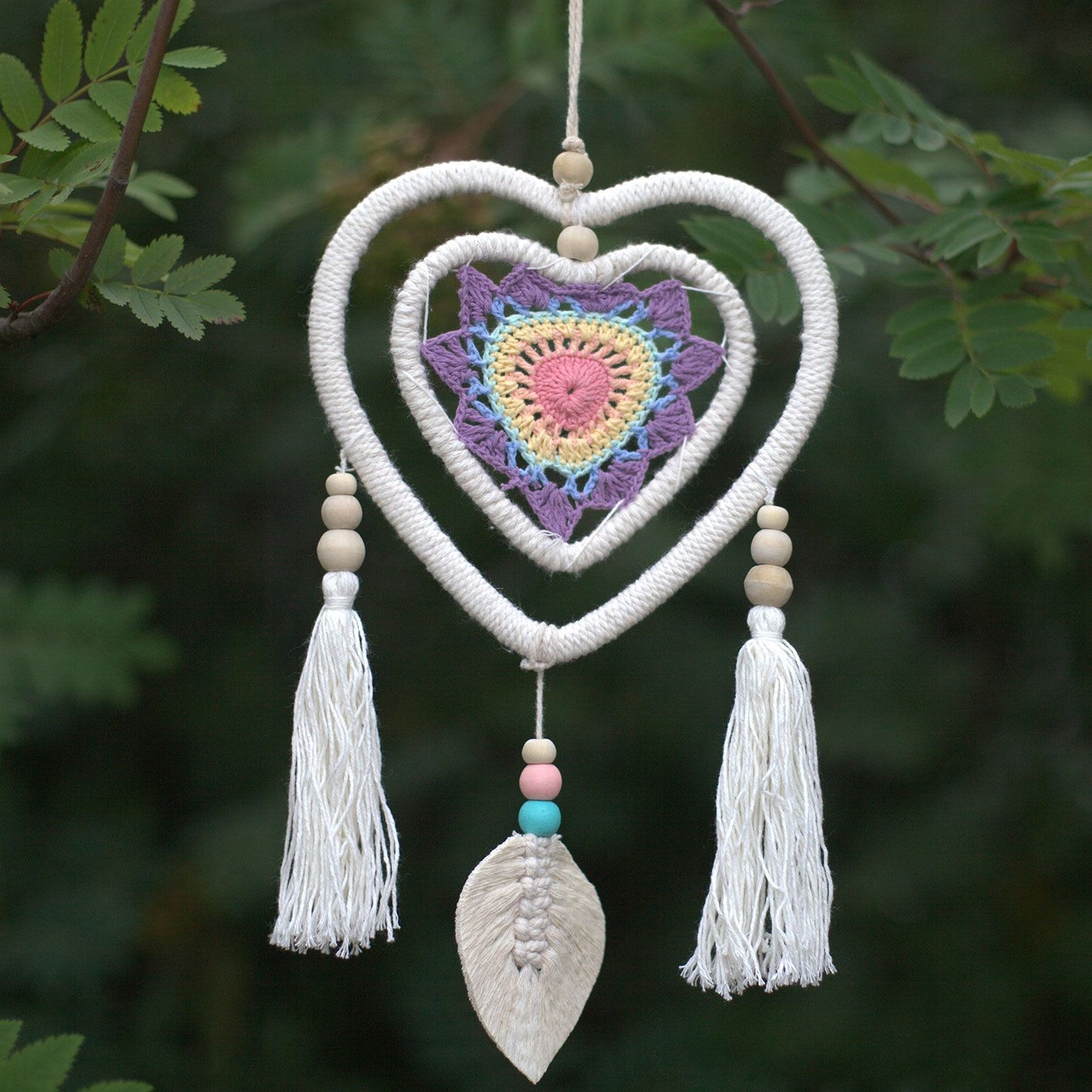 Handmade medium-sized natural dream catcher featuring multiple heart-in-heart woven webs and decorative hanging tails.
