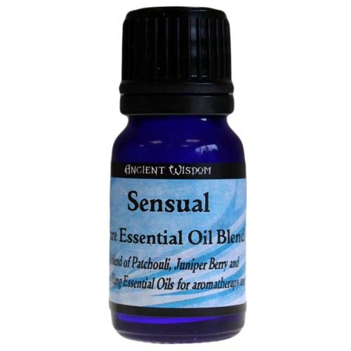 A small amber glass bottle of essential oil blend featuring Patchouli, Juniper Berry, and Ylang Ylang.