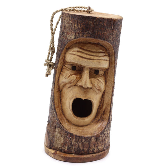 Hand-carved rustic wooden bird house made from a natural tree trunk featuring a detailed grumpy man face.