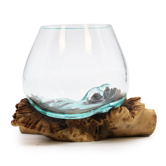 Unique hand-blown clear molten glass bowl artistically draped over a natural rare parasite wood stand.