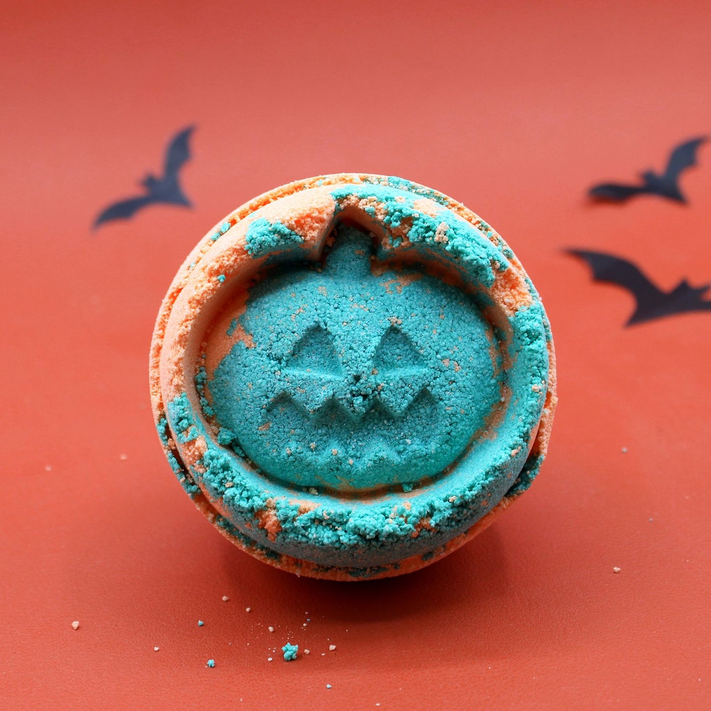 Large artisanal Halloween bath bomb with a textured surface and vibrant orange and fennel-inspired details.