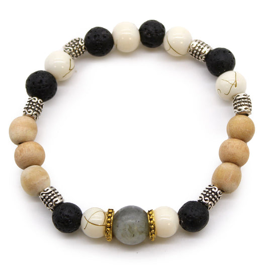 Handcrafted cord bangle featuring white, black, and grey threads woven together in a traditional Balinese style.