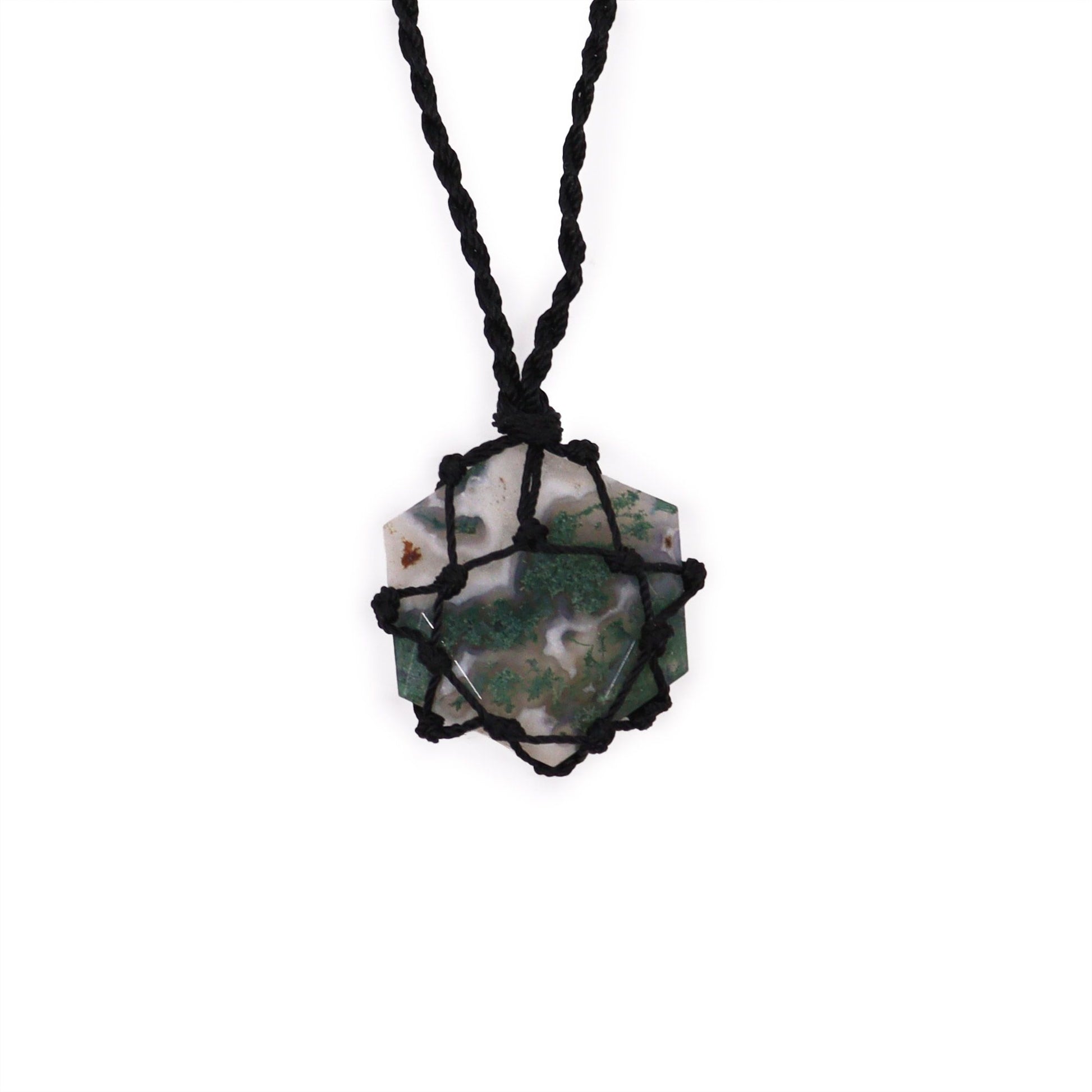 Hexagonal moss agate gemstone pendant featuring natural green patterns and decorative silver-tone metal lacing.