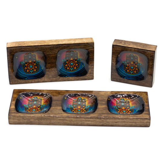 Three nested mango wood trays featuring colourful enamelled Hamsa hand designs in different compartment sizes.