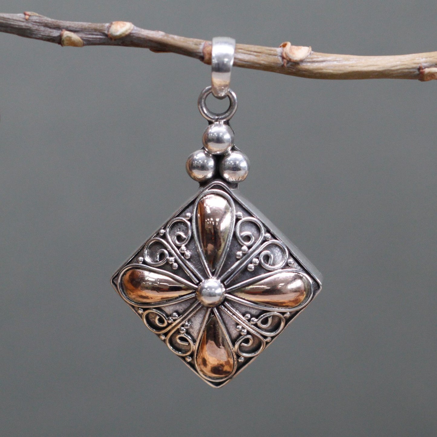Elegant square drop pendant featuring a contemporary blend of silver and gold metals with an exotic textured finish.