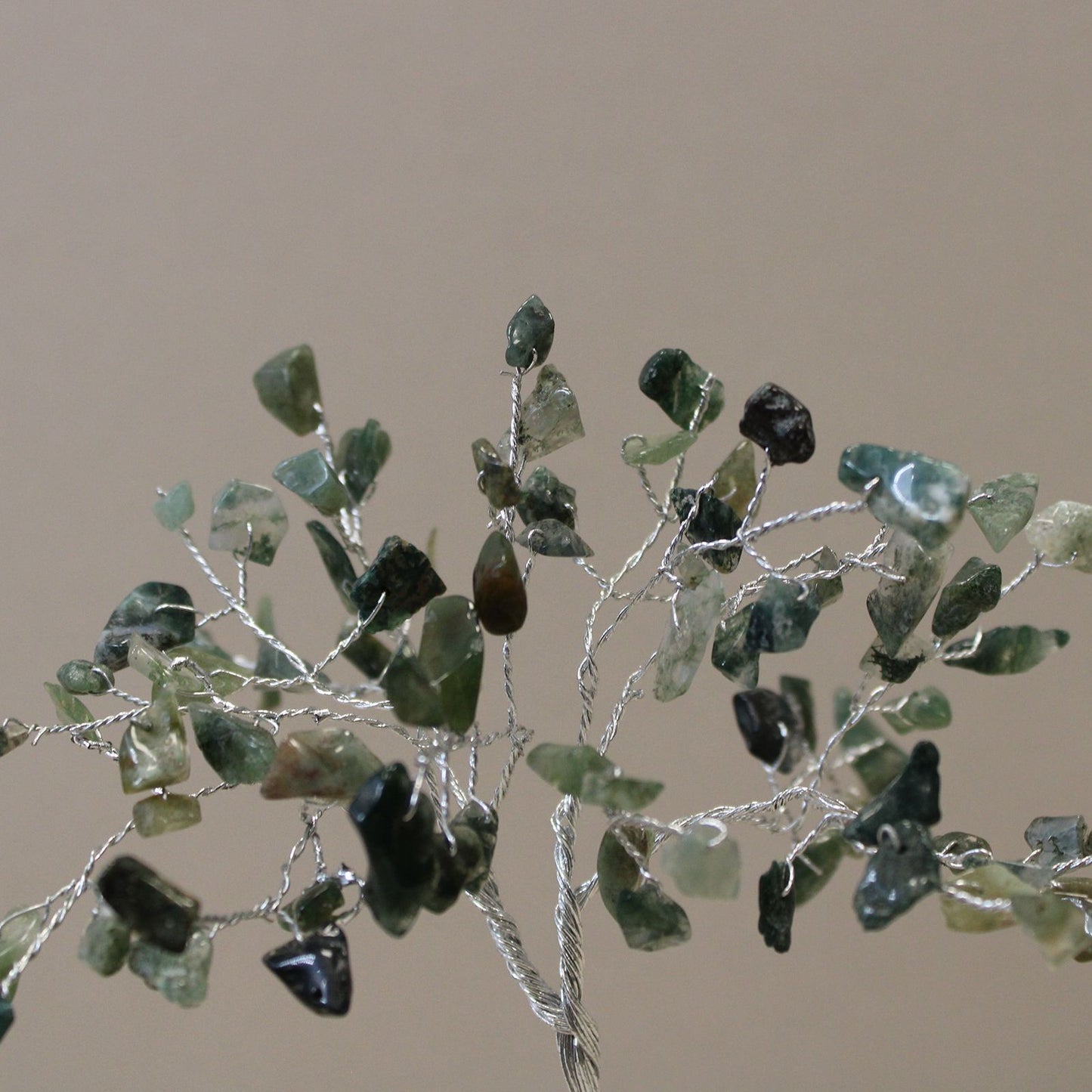 Handcrafted moss agate gemstone tree with eighty green chip stones on a resin orgonite pyramid base with a copper spiral.