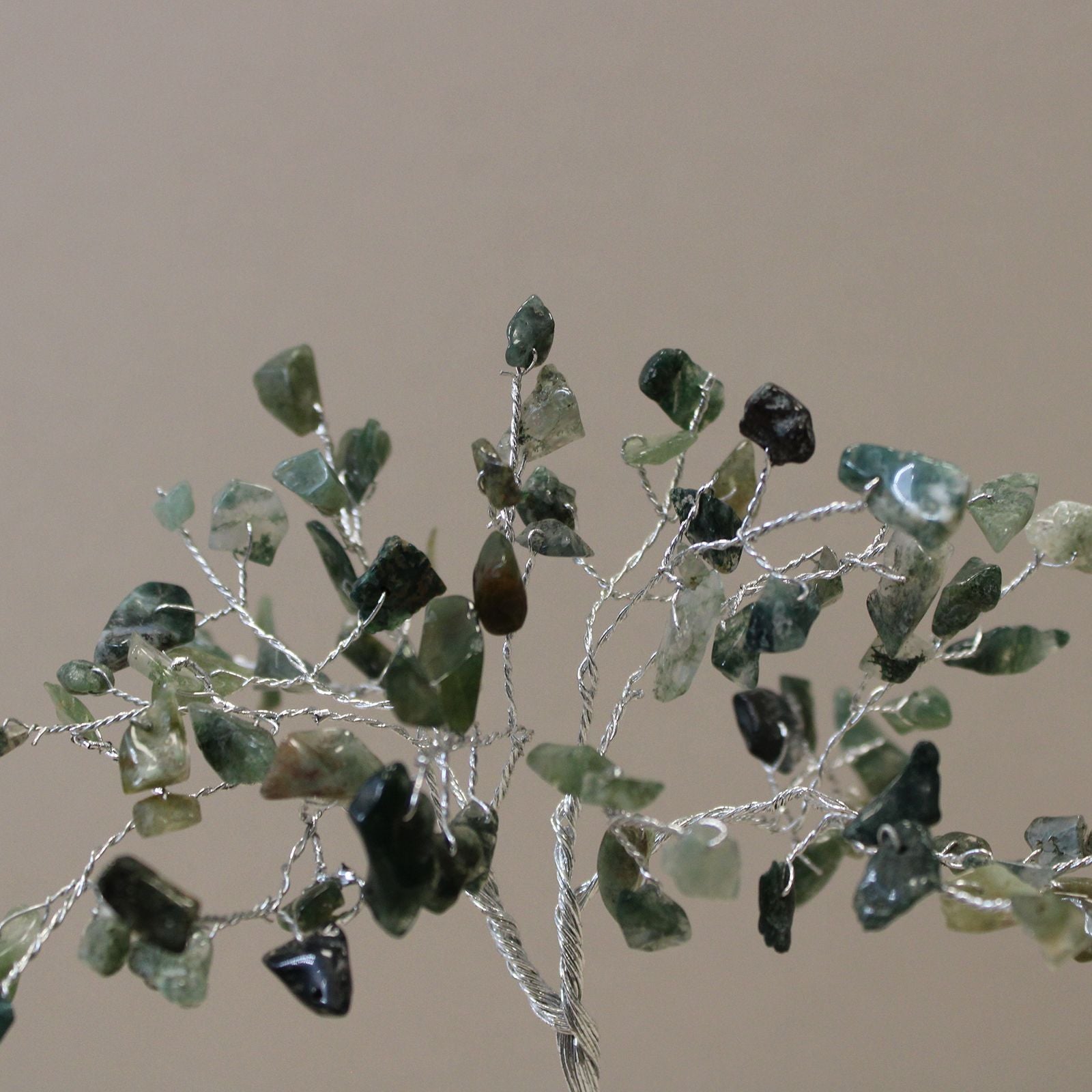 Handcrafted moss agate gemstone tree with eighty green chip stones on a resin orgonite pyramid base with a copper spiral.