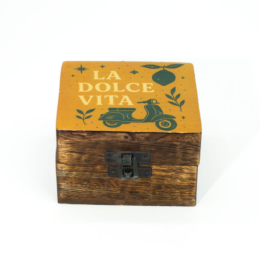 Small mango wood box with an enamelled lid featuring a classic scooter, citrus fruits, and leaves on a sunny background.