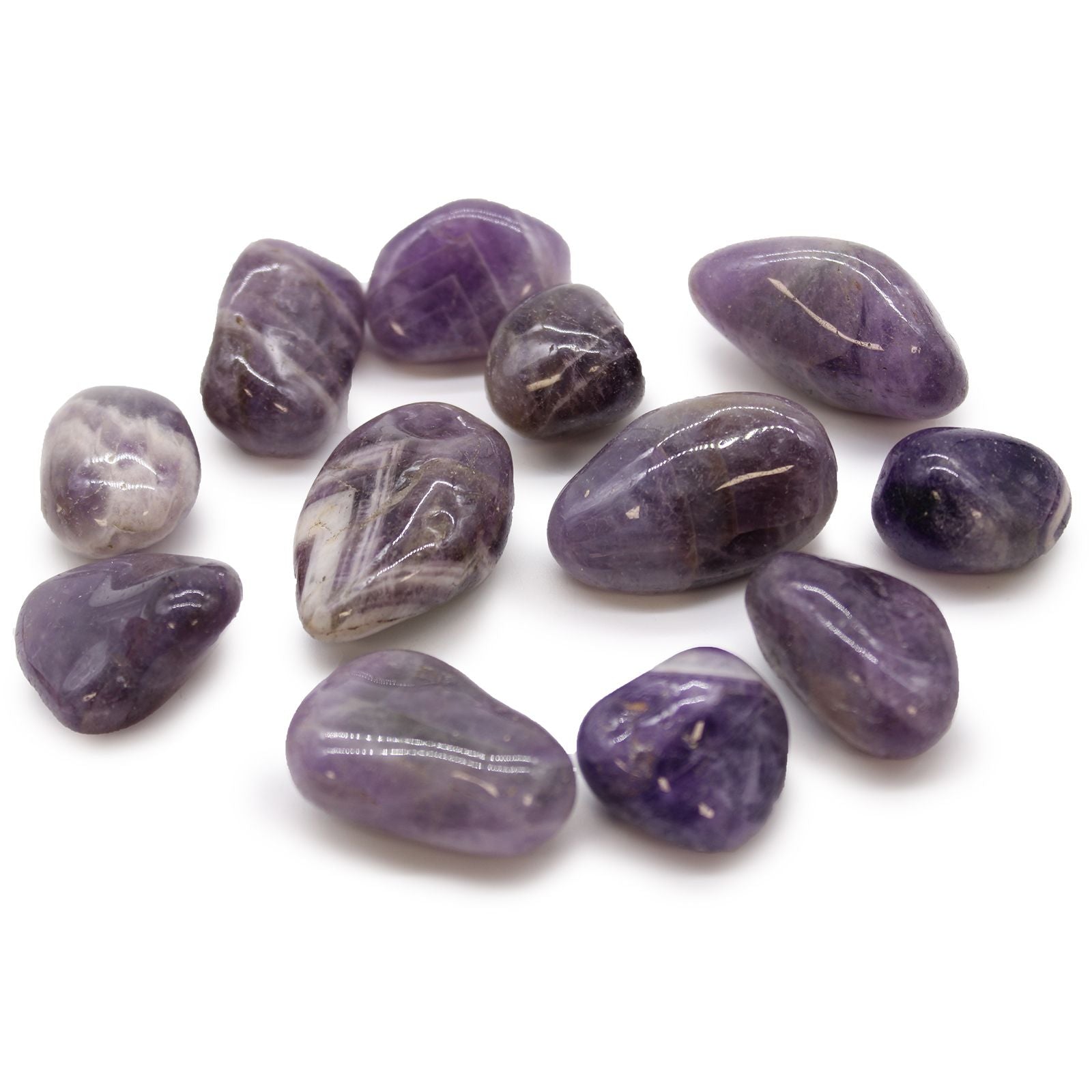 A collection of smooth, polished purple amethyst tumble stones with varying shades of lavender and deep violet.