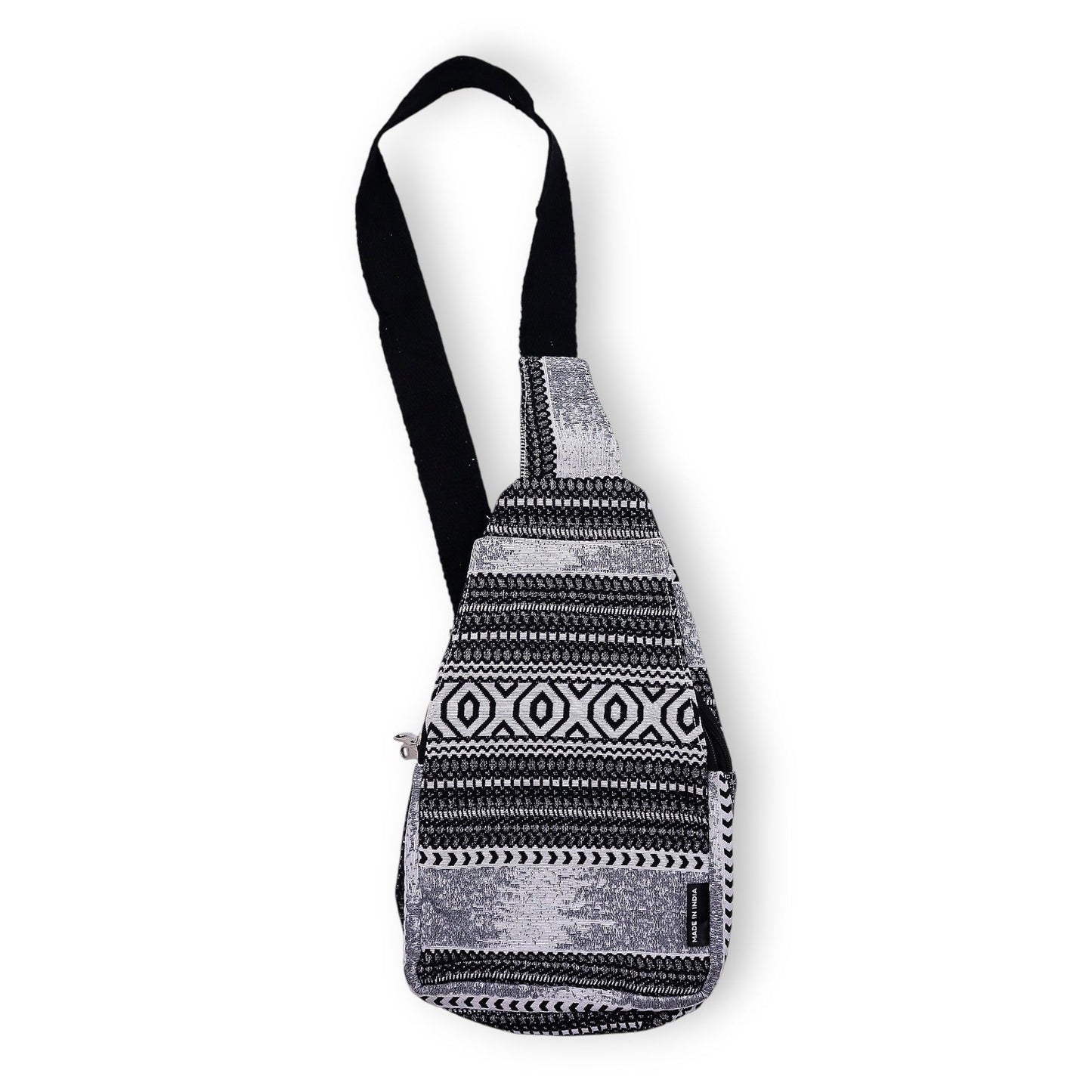 Handmade jacquard crossbody bag with a bold black and white geometric monochrome pattern and a long shoulder strap.