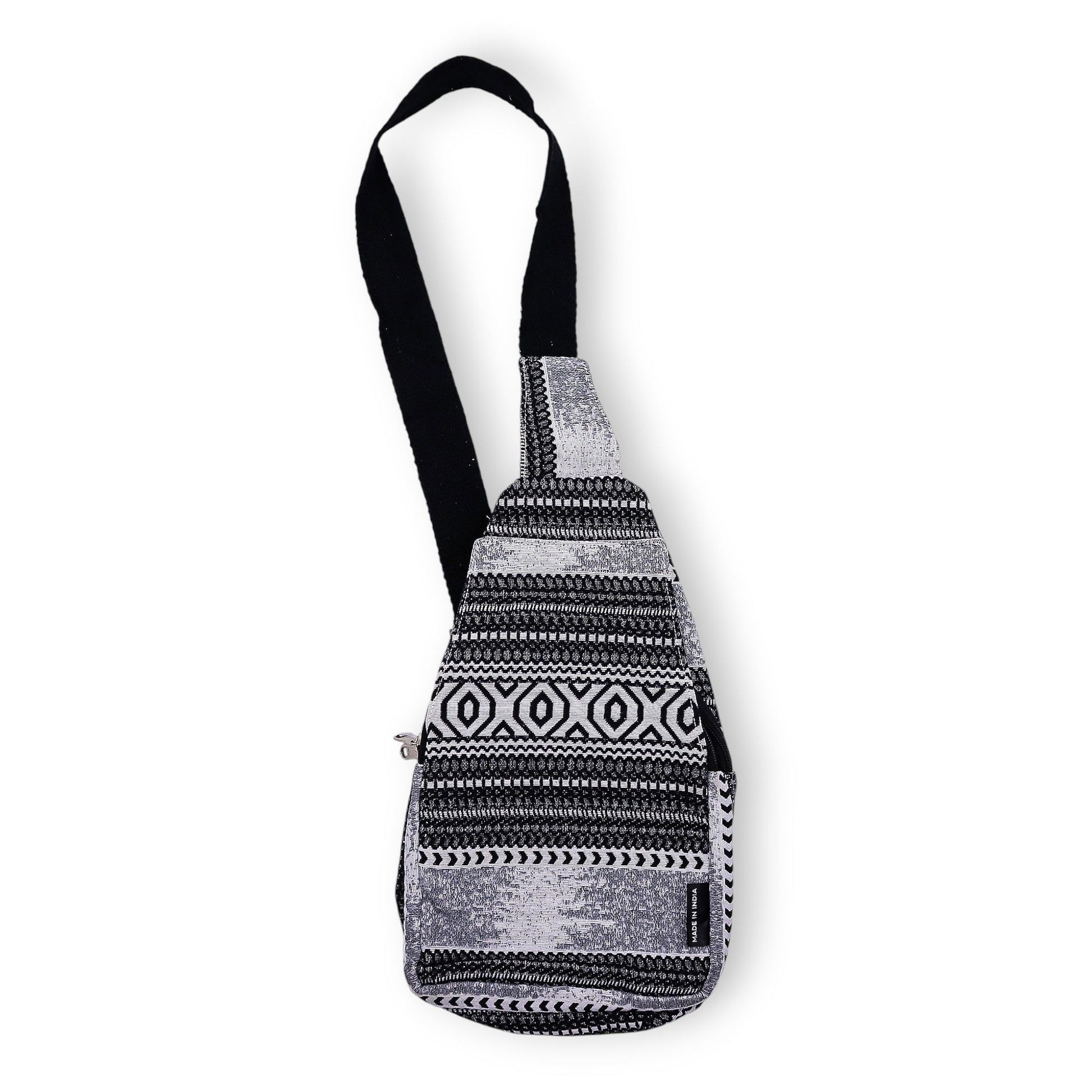 Handmade jacquard crossbody bag with a bold black and white geometric monochrome pattern and a long shoulder strap.