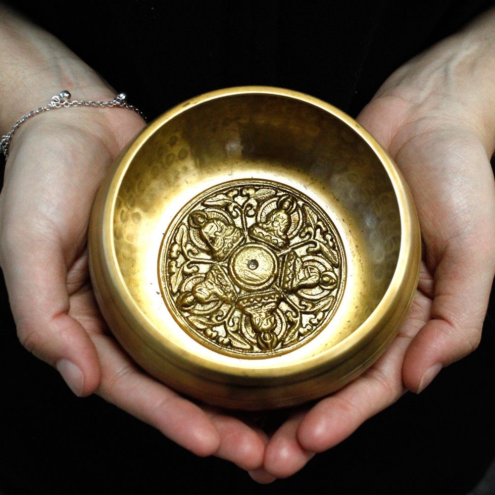 Handcrafted 10cm Tibetan-style singing bowl with intricate Five Buddha engravings and wooden striker.