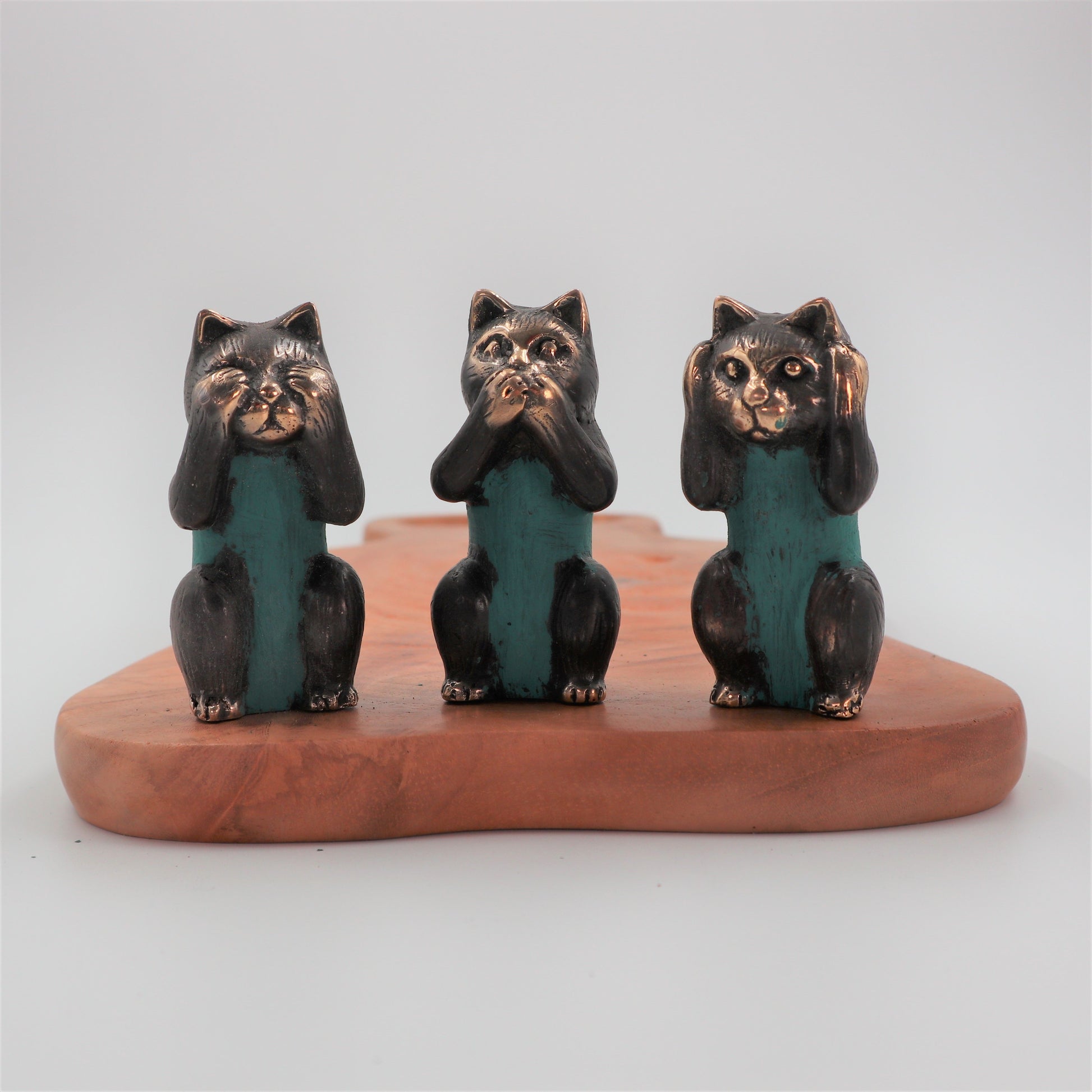 Set of three small polished brass cat figurines representing the See No, Hear No, and Speak No Evil proverbs.