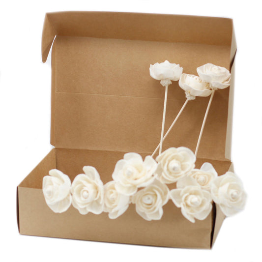 Handcrafted white sola wood rose flower attached to a natural reed stick for aromatherapy diffusers.