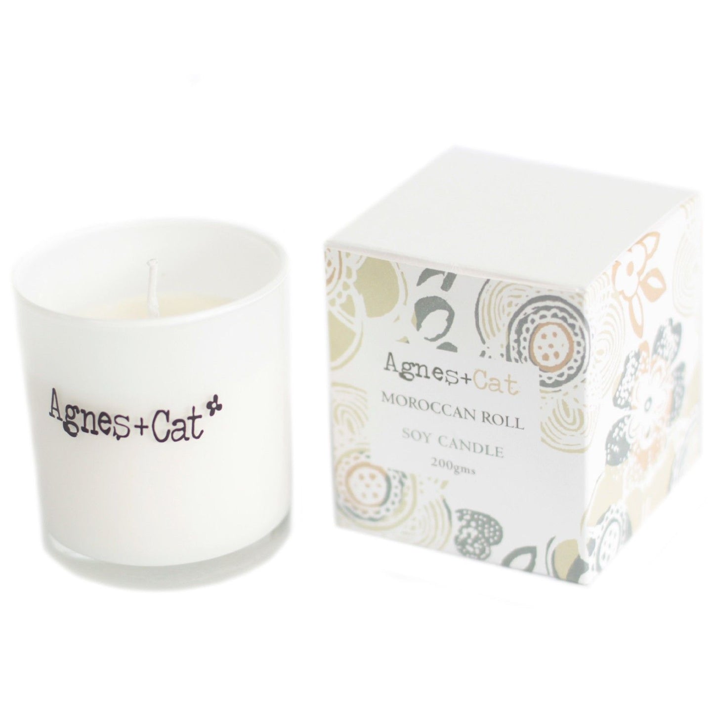 Small cream-coloured votive candle in a clear glass holder, featuring a simple paper label with black text.