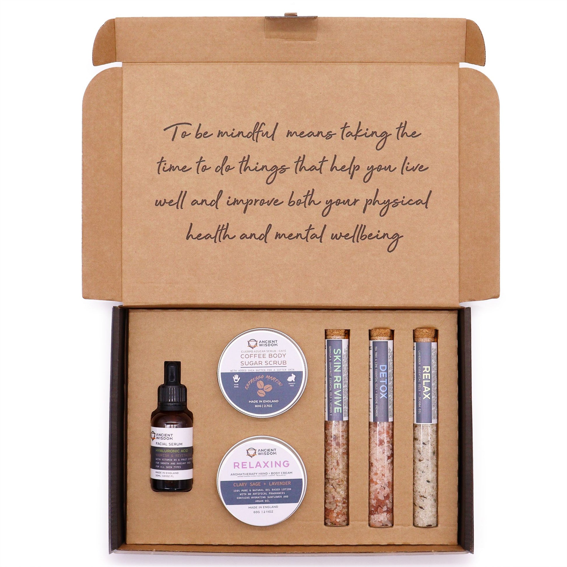 Luxury self-care gift set featuring a jar of coffee sugar body scrub and a tin of relaxing body cream.
