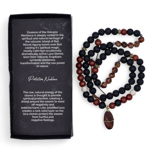 Close-up of a spiritual protection necklace featuring dark, porous black lava stone beads on a simple cord.