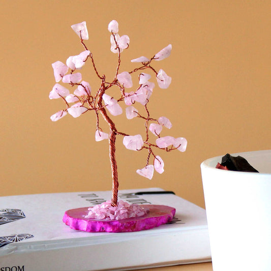 Delicate gemstone tree with pink rose quartz crystal leaves on a polished pink agate slice base with gold wire branches.