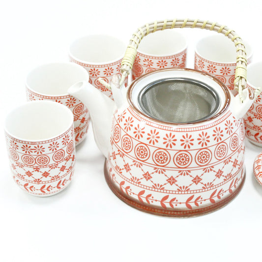 Elegant amber-toned glass teapot with a metal strainer lid and six matching small amber tea cups.