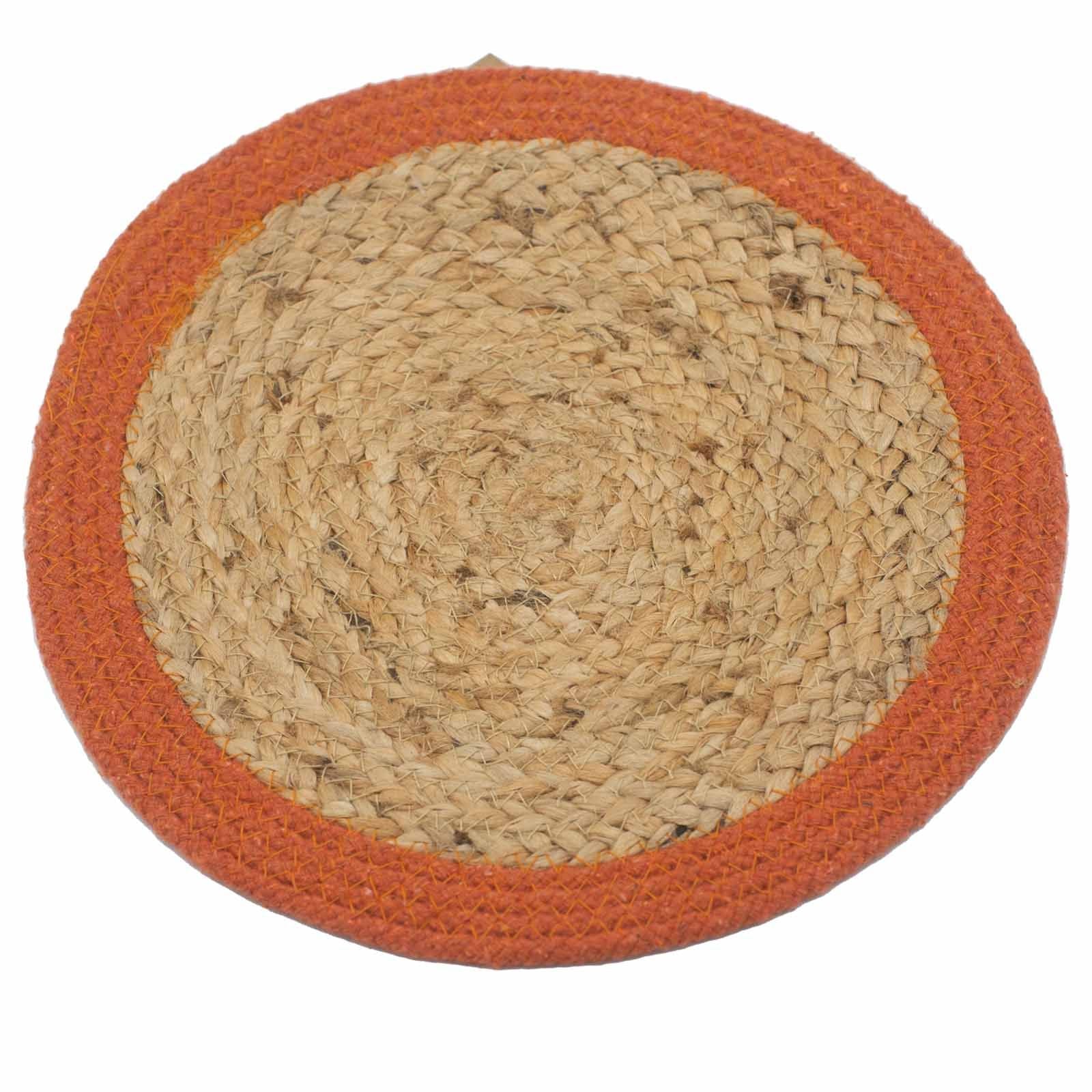 Round natural jute and cotton woven placemat with a decorative earthy clay coloured border on a neutral background.